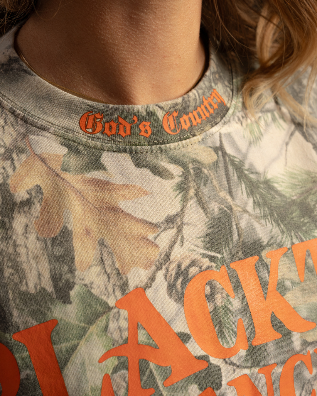 Macro shot of Take The Shot graphic print on forest camo t-shirt Blacktop Ranch