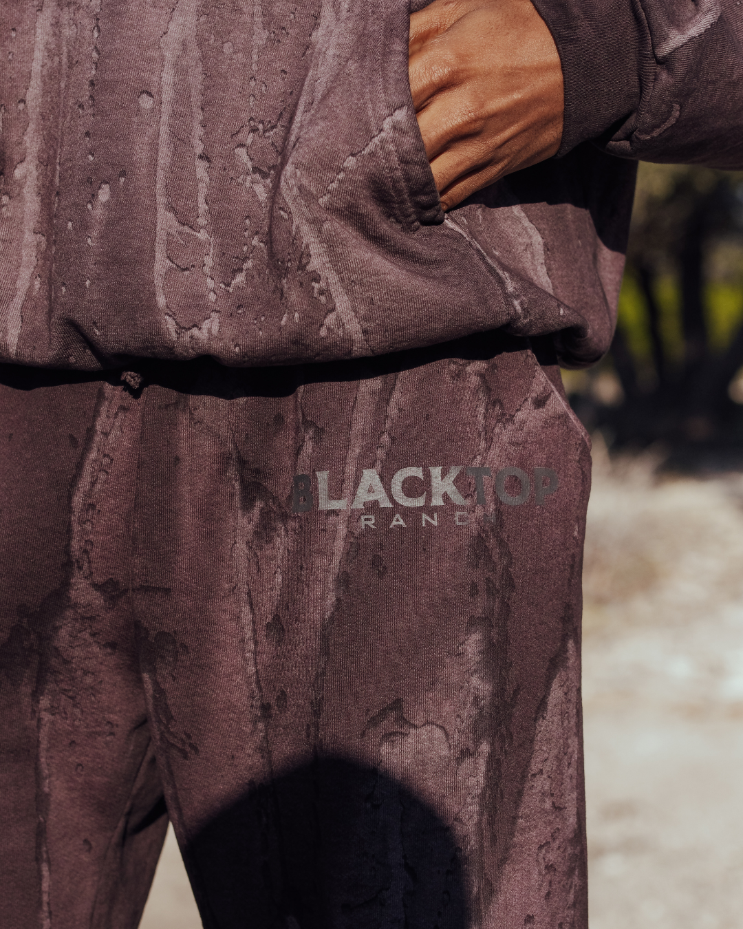 Close-up of drip dye pattern on Blacktop Ranch BTR sweatpants