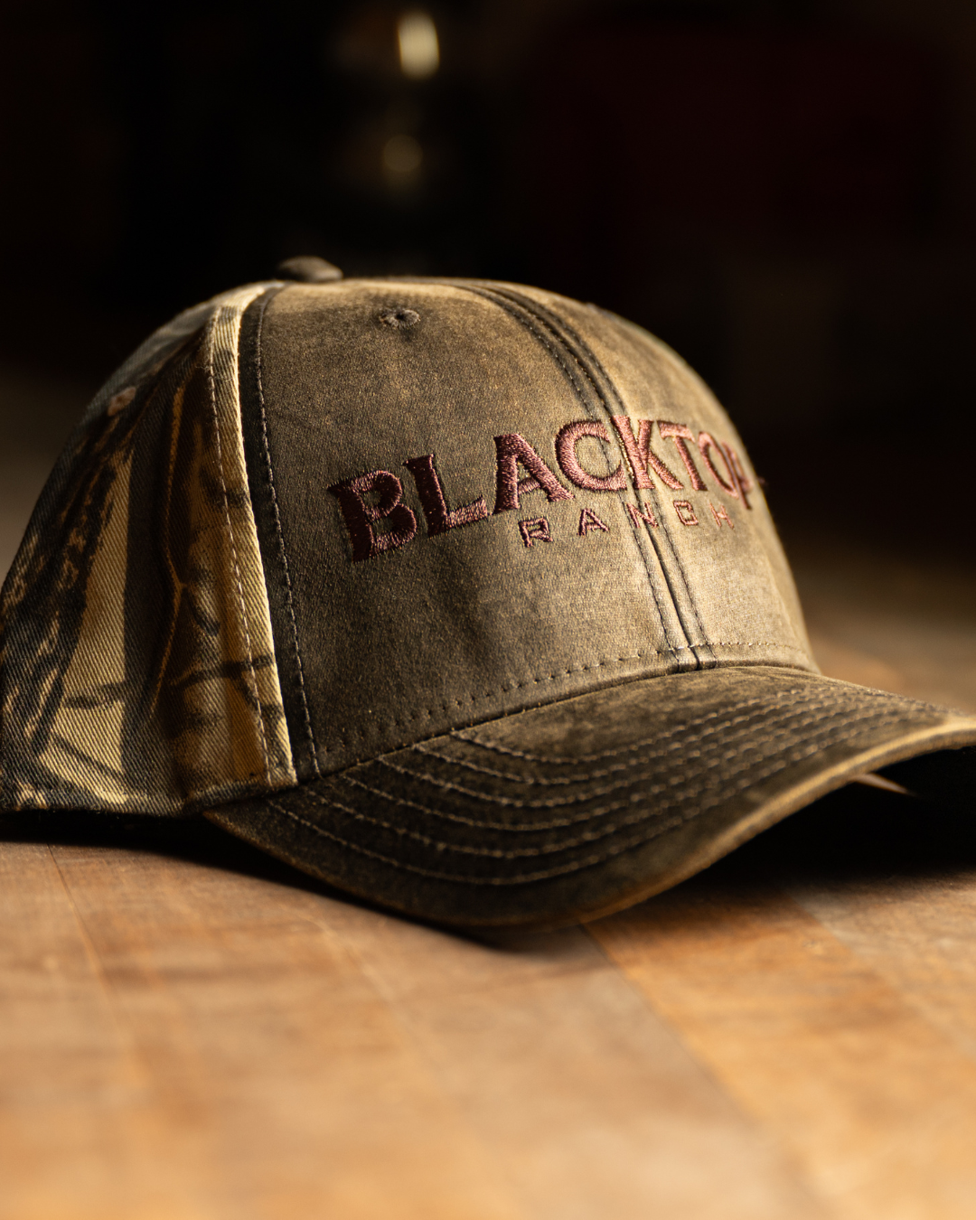 Side profile of camo trucker hat with curved brim by Blacktop Ranch
