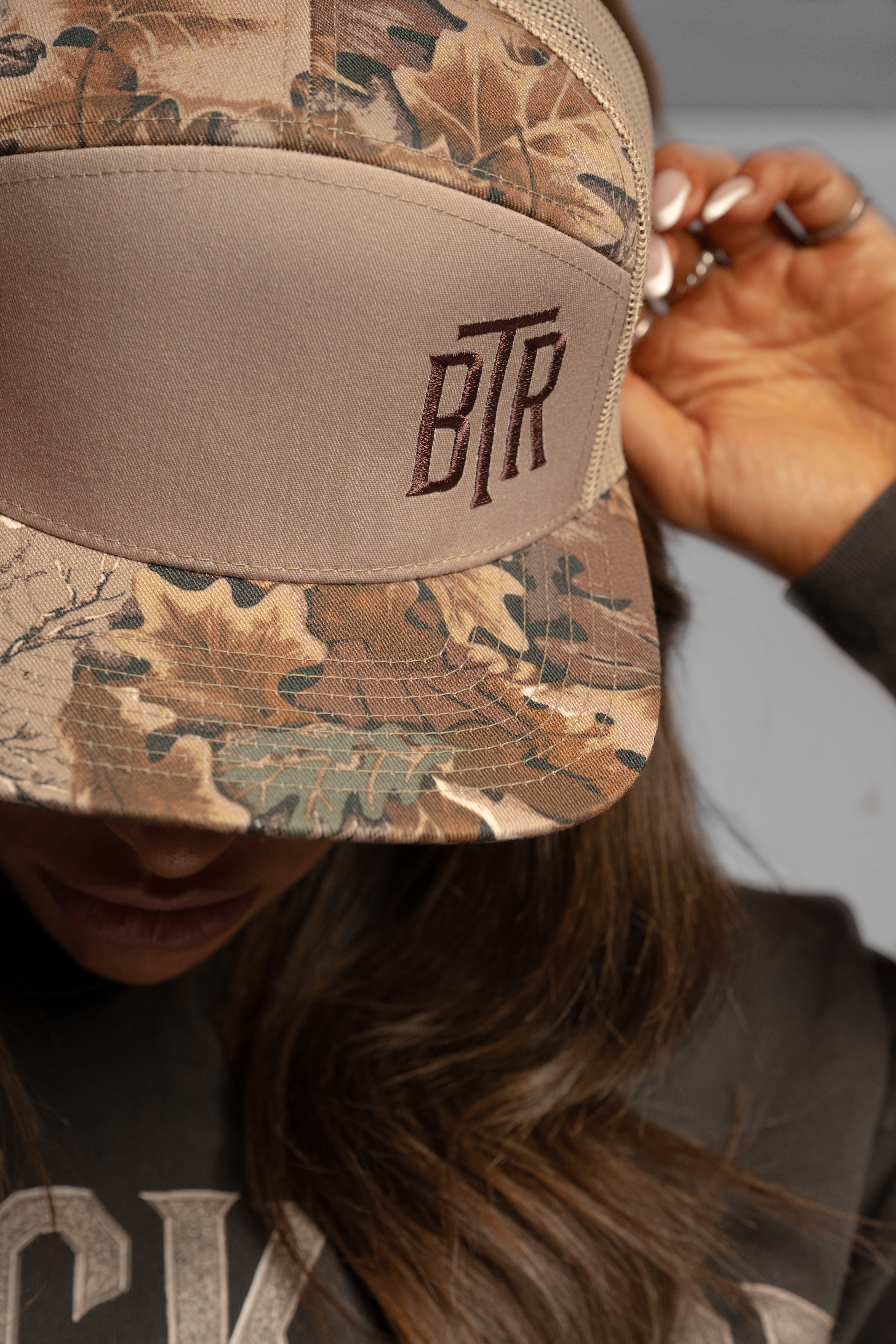 Close-up of Blacktop Ranch camo cap stitching and front panel structure