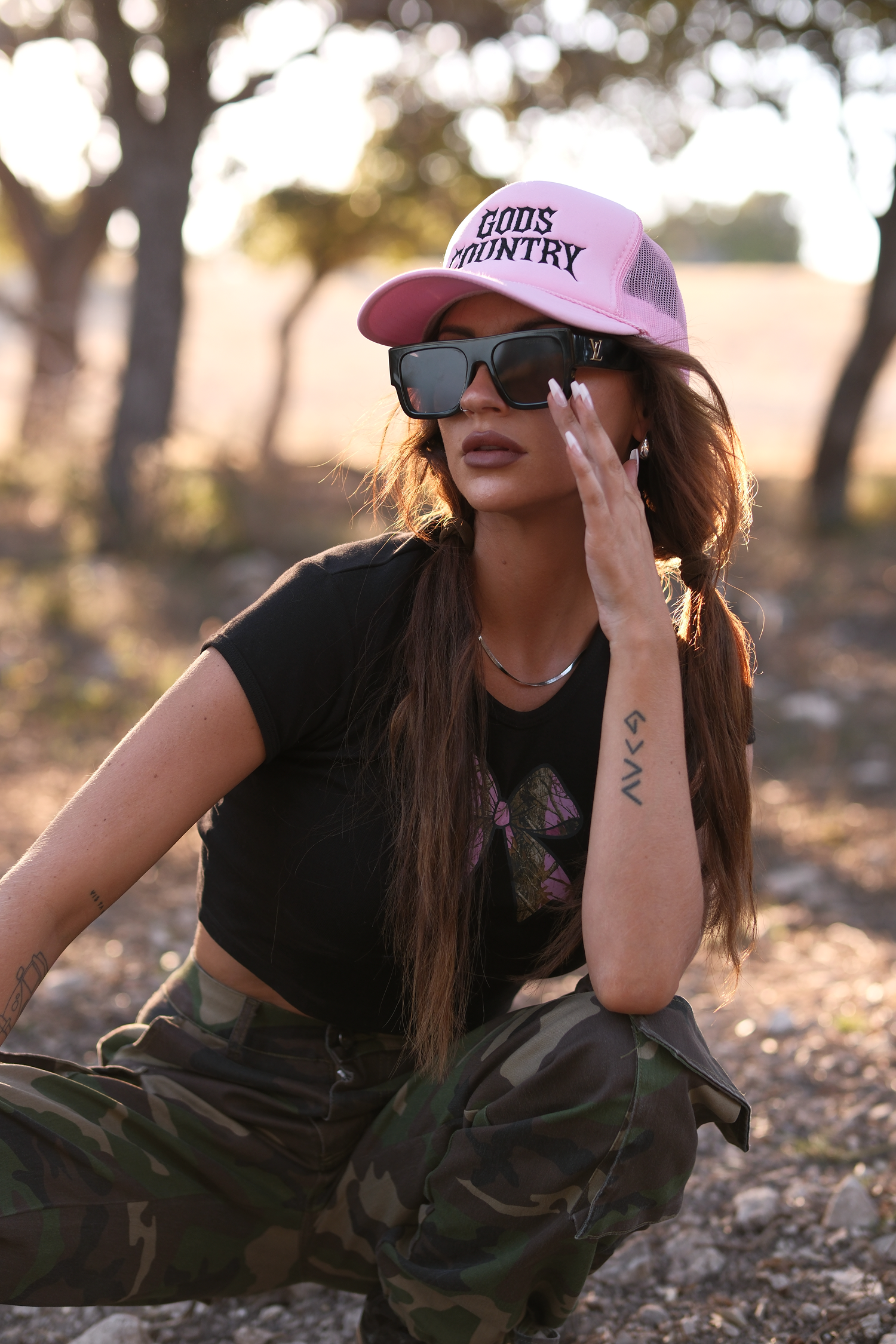 Pink God’s Country trucker hat styled outdoors with western ranch aesthetic and natural light